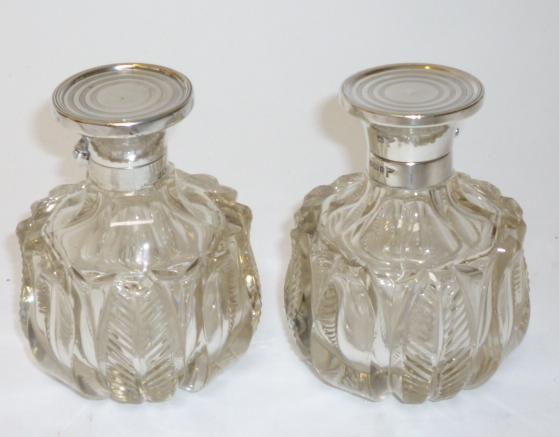 Appraisal: A PAIR OF CLEAR GLASS SCENT BOTTLES maker Walker Hall