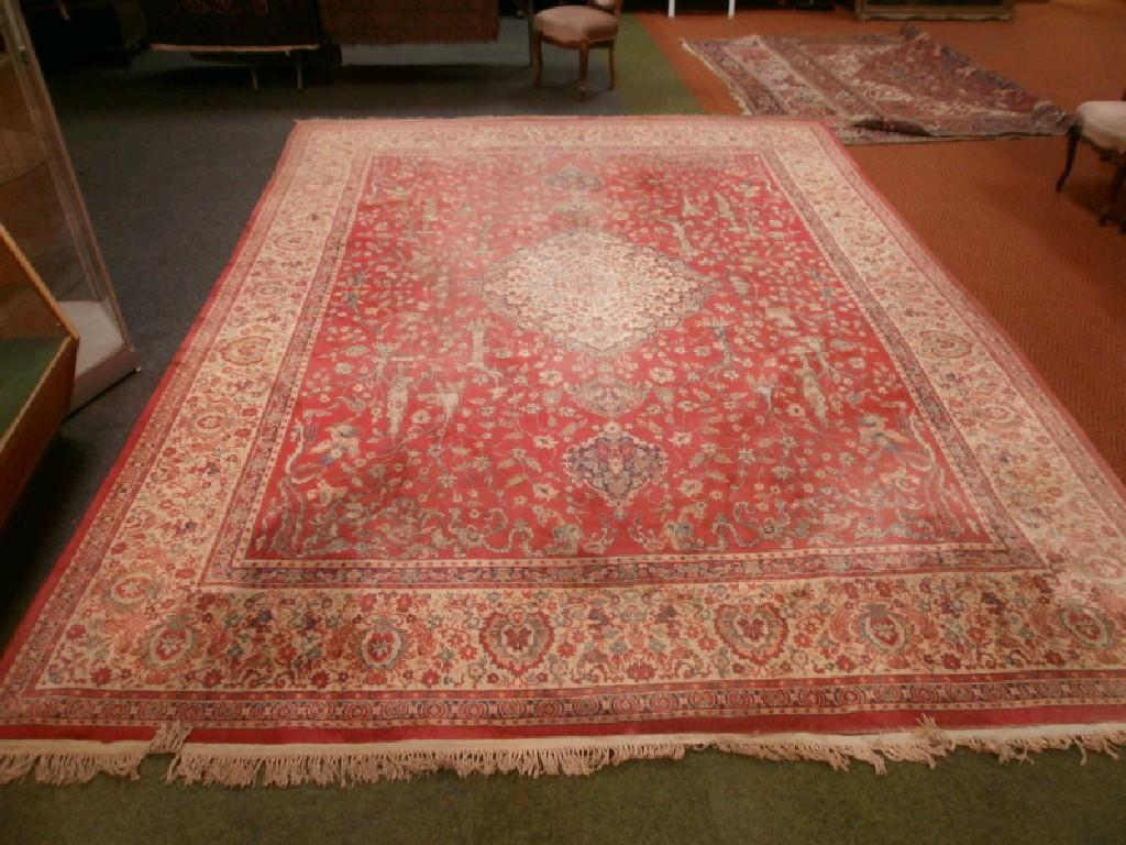 Appraisal: A bordered carpet with central medallion and stylized trees and