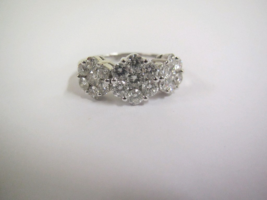 Appraisal: Eighteen carat white gold triple flower head diamond cluster ring