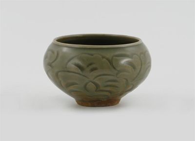 Appraisal: A Chinese Northern celadon bowl the exterior carved with stylized