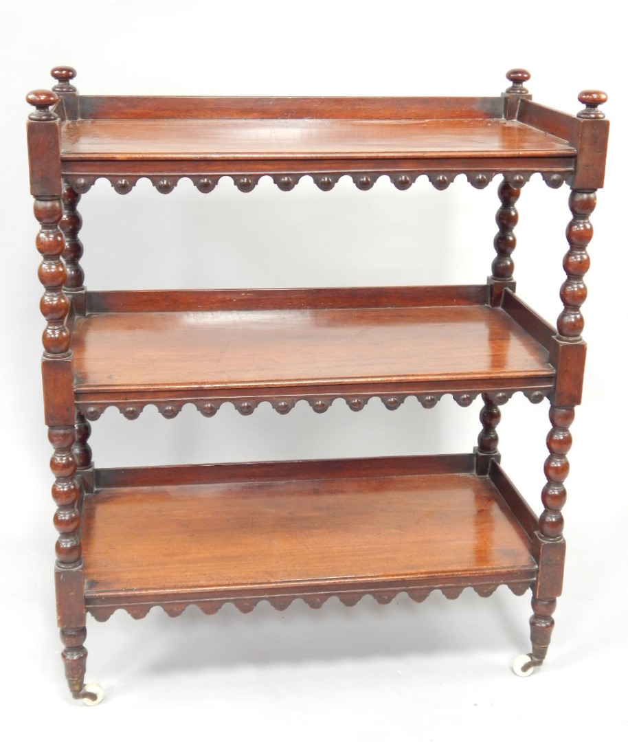 Appraisal: A Victorian mahogany three galleried tiered buffet with bobbin turned