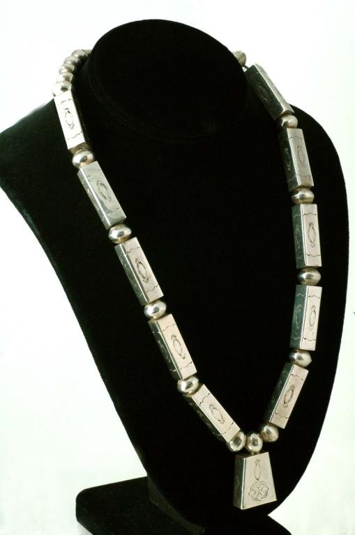 Appraisal: An unusual form necklace consisting of alternating round seamed beads