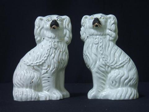 Appraisal: PAIR OF STAFFORDSHIRE SPANIELS Modeled seated with a locked collar