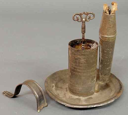 Appraisal: Tin lighting device c with a key wind clockwork mechanism