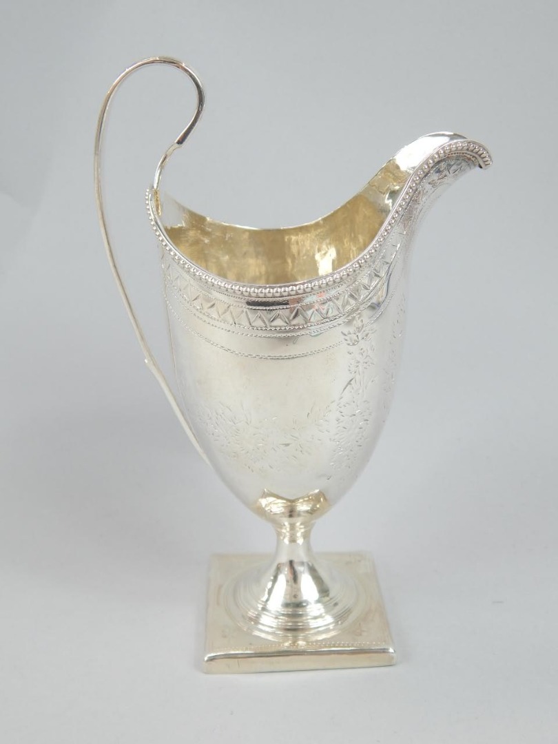 Appraisal: A William IV silver cream jug the helmet shaped body