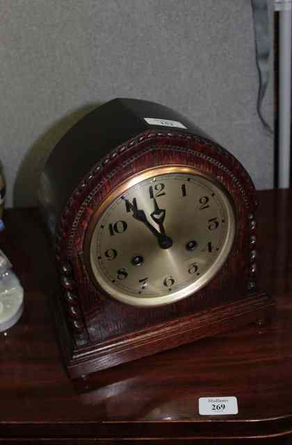 Appraisal: AN OAK CASED MANTEL CLOCK the silvered dial with Arabic