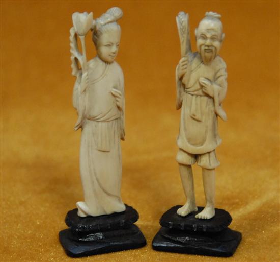 Appraisal: PAIR CHINESE CARVED IVORY FIGURES Male and female Mounted on