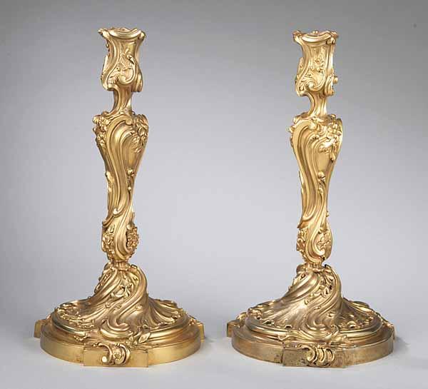 Appraisal: A Pair of French Polished Bronze Candlesticks in the Rococo