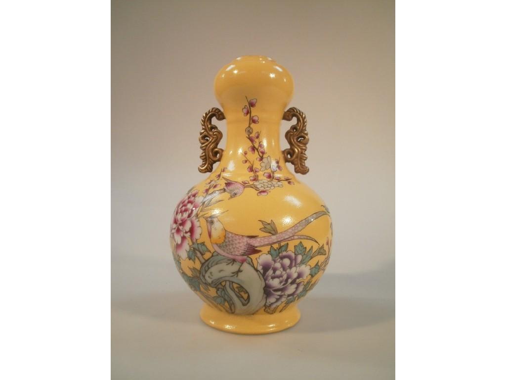 Appraisal: A yellow ground Chinese gourd vase with gilded handle decorated