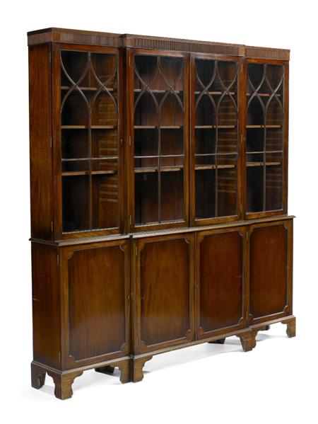 Appraisal: A George III style mahogany breakfront bookcase the reeded cornice