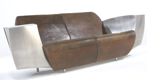 Appraisal: JONATHAN SINGLETON Stainless steel sofa with distressed brown leather upholstery