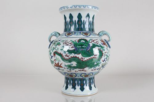 Appraisal: A CHINESE DUO-HANDLED DRAGON-DECORATING PORCELAIN FORTU A Chinese Duo-handled Dragon-decorating