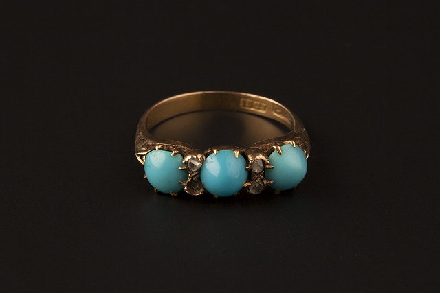 Appraisal: A TURQUOISE AND DIAMOND HALF HOOP RING the oval cabochon