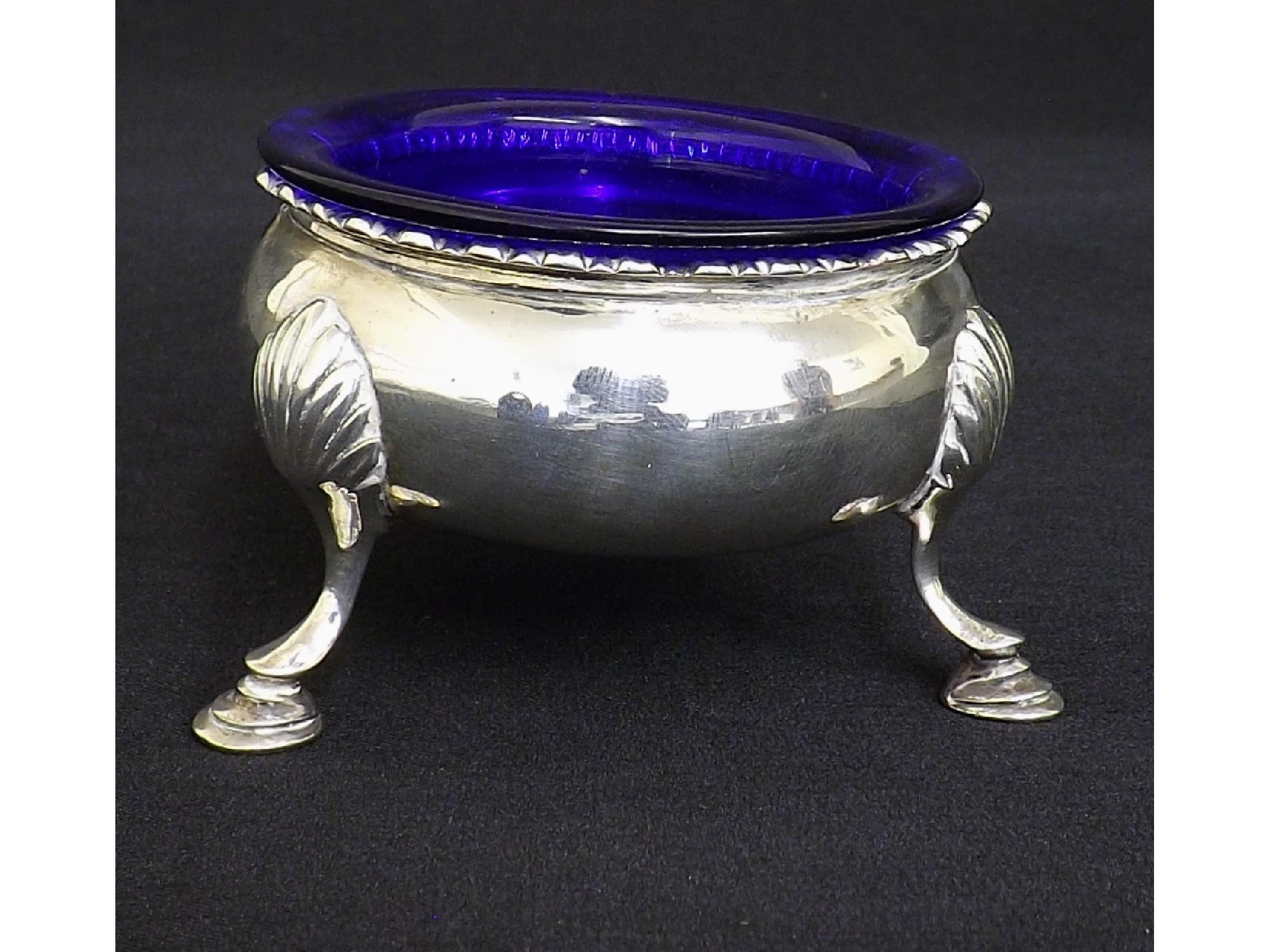 Appraisal: George III silver circular table salt upon cabriole shell hoof