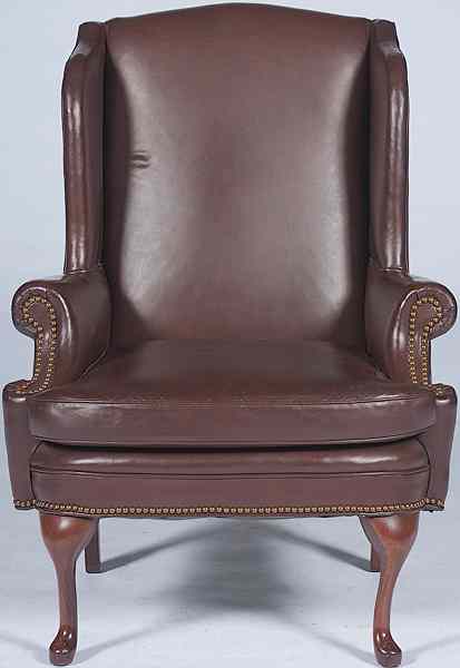 Appraisal: Brown Leather Wing Chair th century a brown leather wing