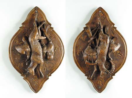 Appraisal: A PAIR OF CONTINENTAL CARVED WOOD GAME PLAQUES Late th