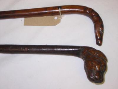 Appraisal: A VICTORIAN FRUITWOOD WALKING STICK the grip carved as a