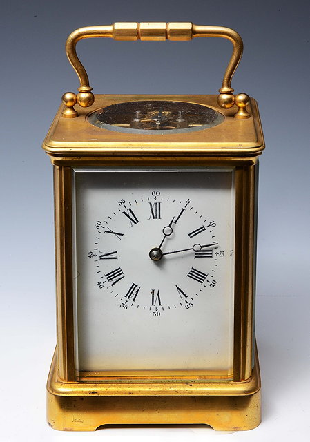 Appraisal: A FRENCH CARRIAGE CLOCK with white enamel Roman dial and