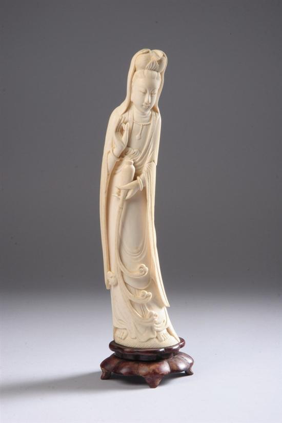 Appraisal: CHINESE IVORY FIGURE OF GUANYIN Standing wearing long robes veil