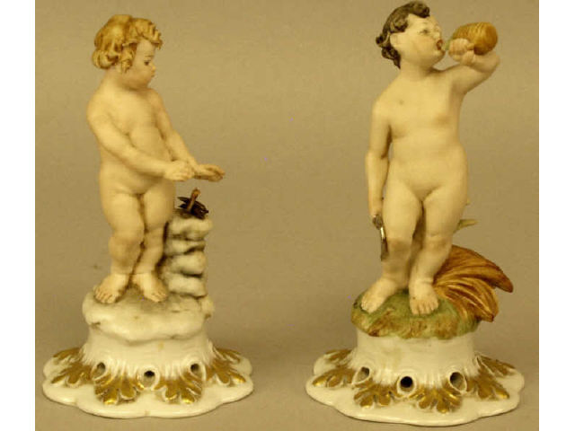 Appraisal: A pair of hand painted porcelain figurines depicting a young