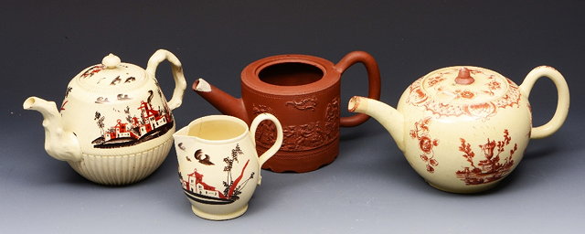 Appraisal: AN ENGLISH CREAMWARE TEAPOT AND COVER with iron red foliate