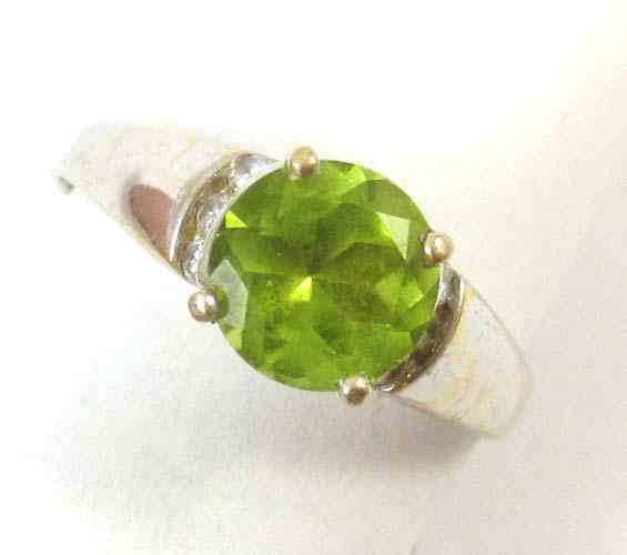 Appraisal: PERIDOT DIAMOND AND WHITE GOLD RING The k gold ring