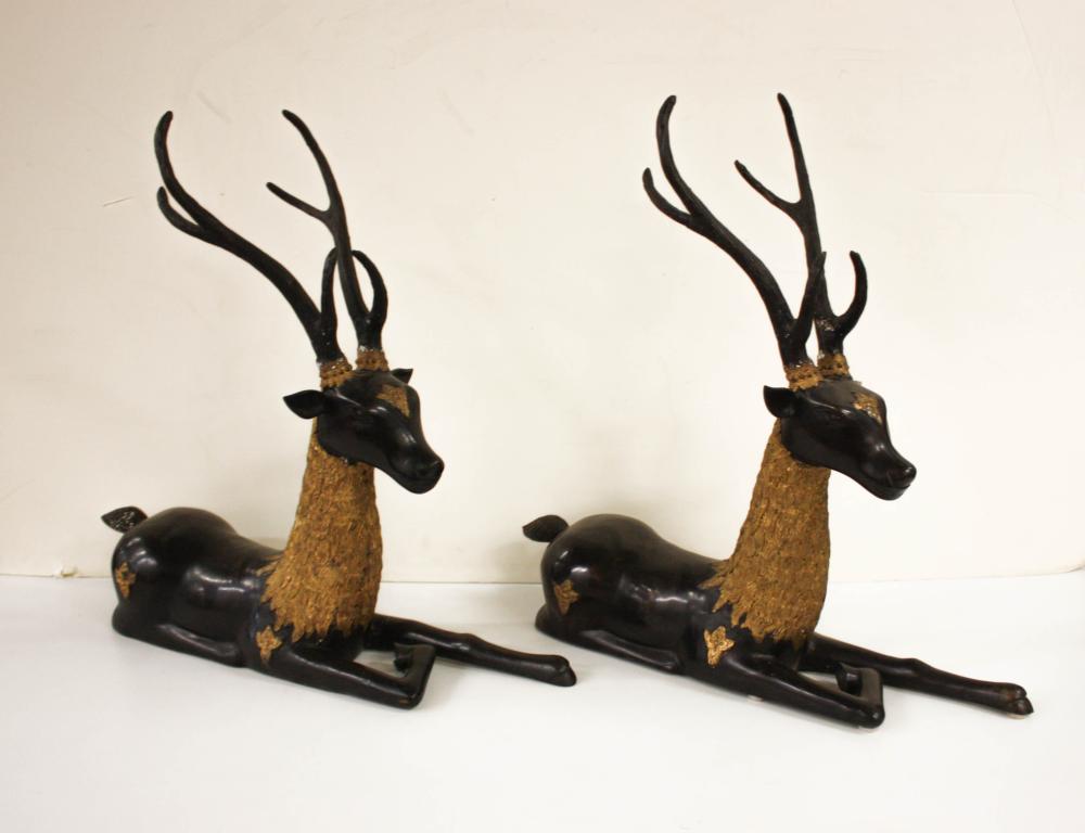 Appraisal: A PAIR OF PARCEL-GILT AND PATINATED BRONZE RECUMBENT DEER H