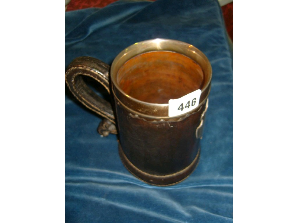 Appraisal: A leather mounted turned wood jug of tapering form with