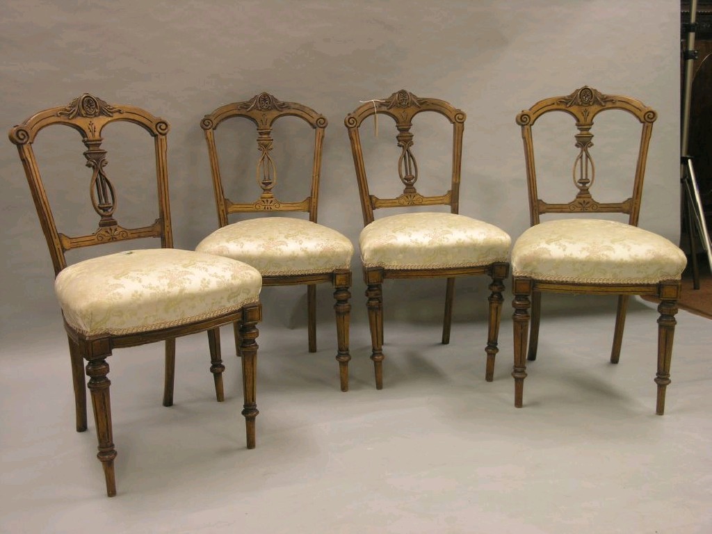 Appraisal: A set of four Victorian carved walnut dining chairs with