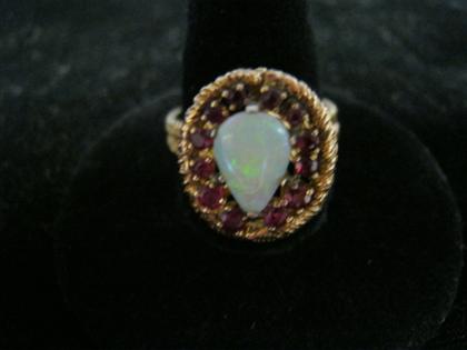 Appraisal: Yellow gold opal and ruby ringPear shaped opal surrounded by