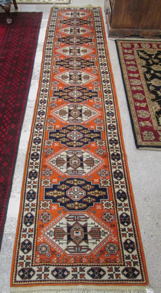 Appraisal: HAND KNOTTED ORIENTAL RUNNER Pakistani Carghi featuring a full-length column