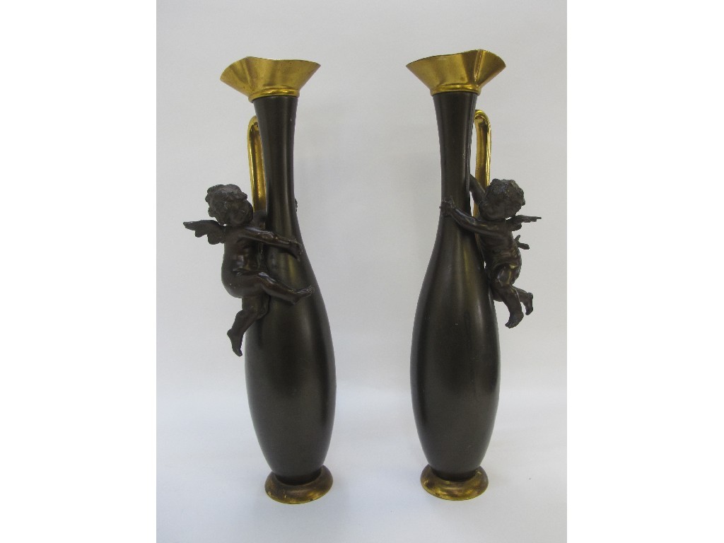 Appraisal: Pair of bronzed vases mounted with cherubs