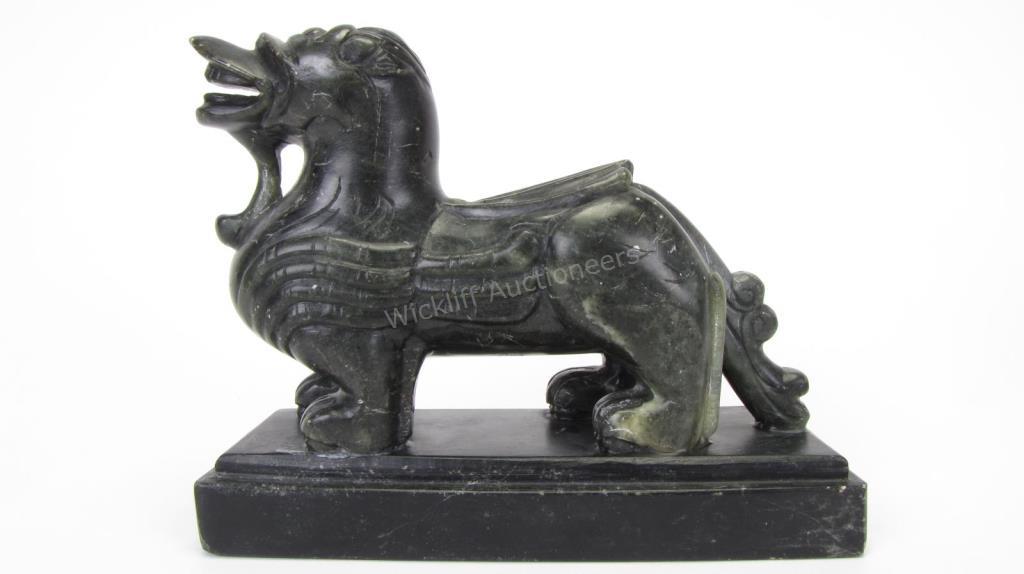 Appraisal: Oriental Spinach Jade Sculpture depicting standing temple lion on black