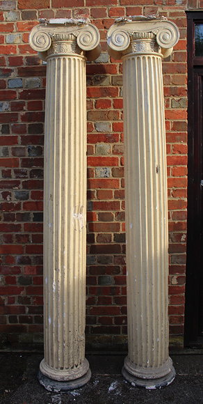 Appraisal: A PAIR OF PLASTER IONIC ARCHITECTURAL COLUMNS with fluted shafts