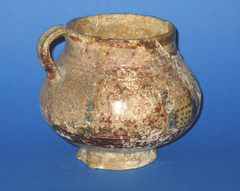 Appraisal: A KASHAN POTTERY CUP covered in a lustrous tin-glaze the