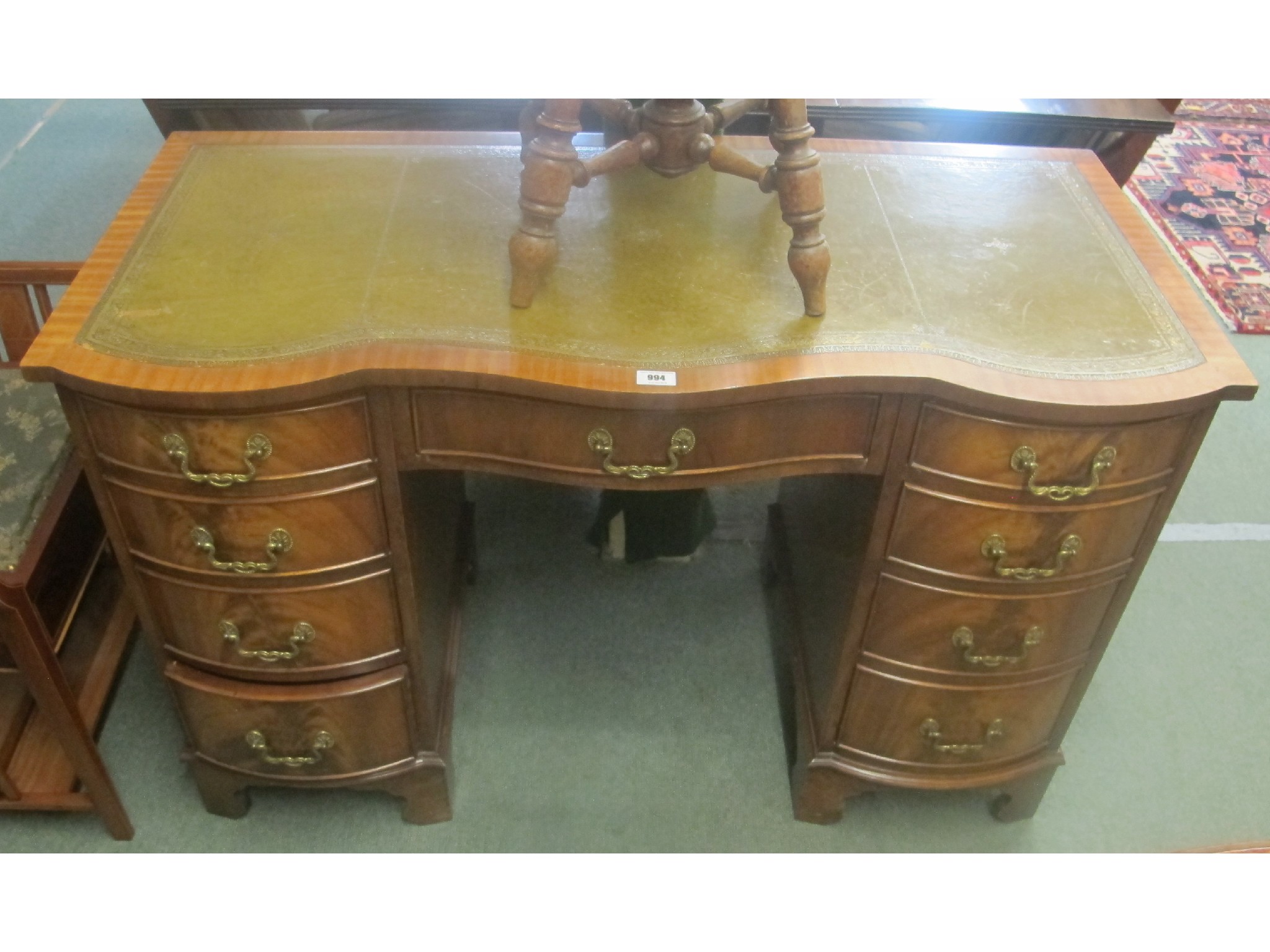 Appraisal: A reproduction leather topped pedestal desk