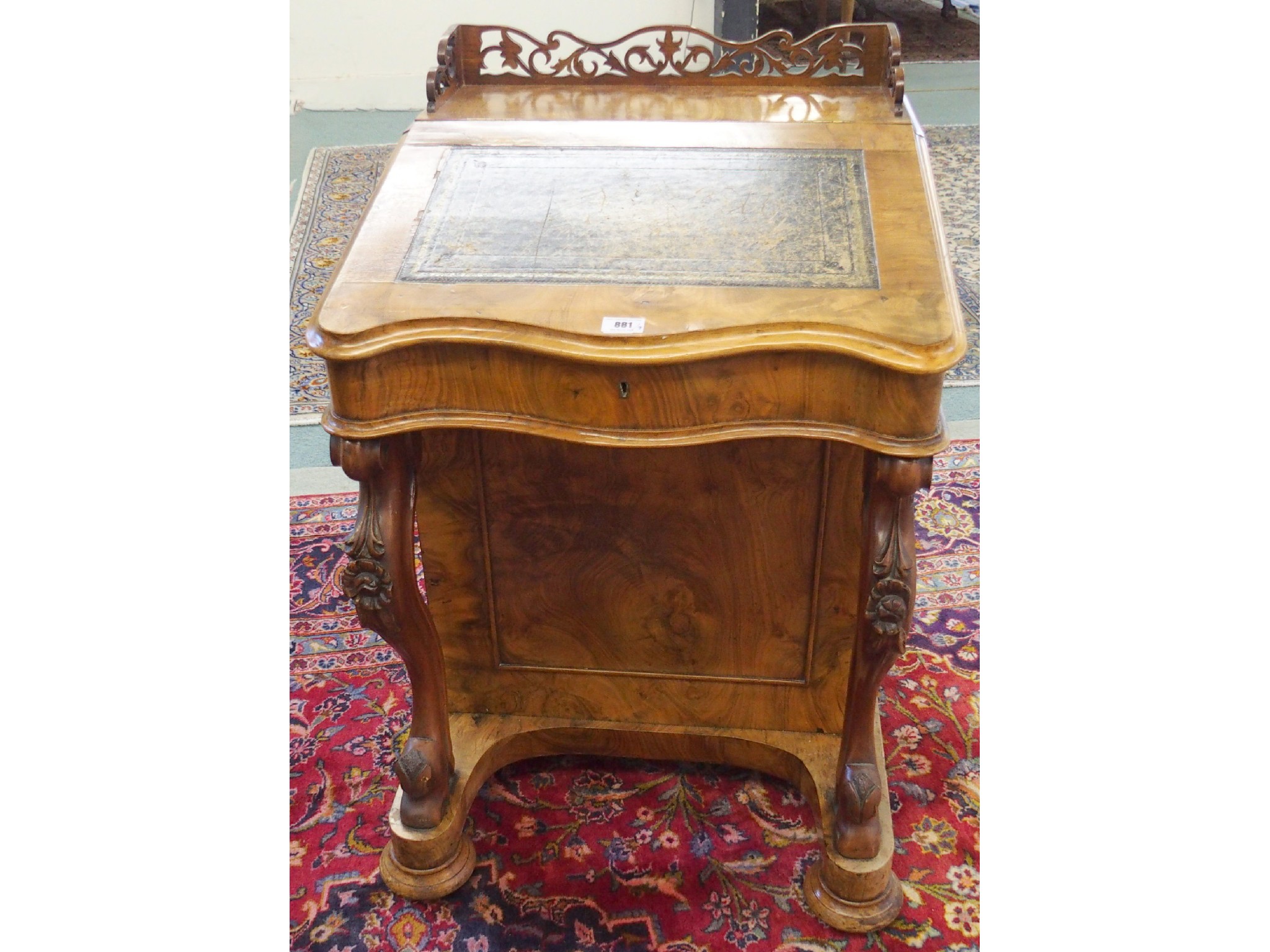 Appraisal: A Victorian walnut Davenportof traditional type with foliate scroll legs