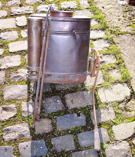 Appraisal: A copper knapsack sprayer with attachments