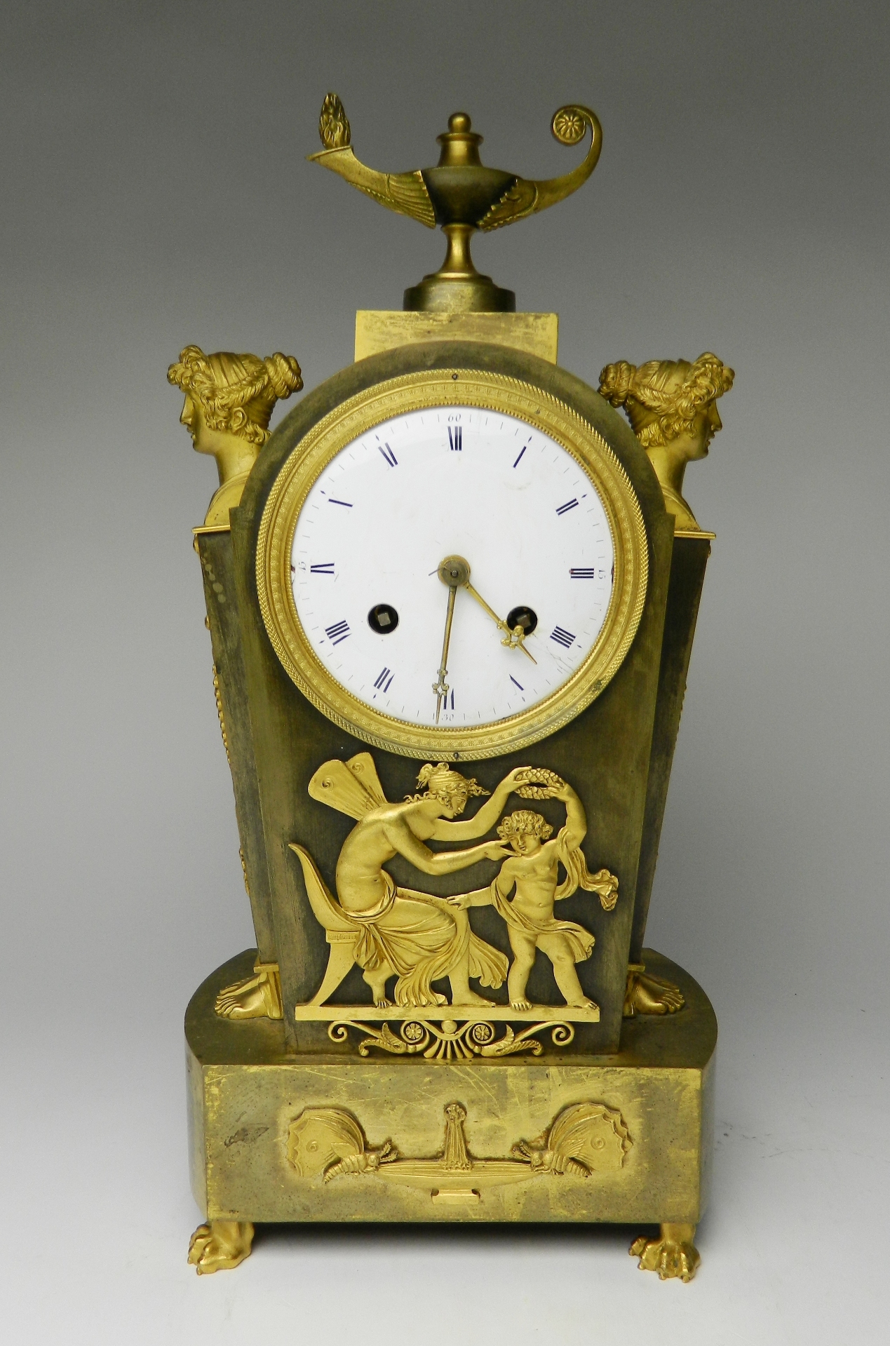 Appraisal: A French Empire gilt bronze mantle clock with circular enameled