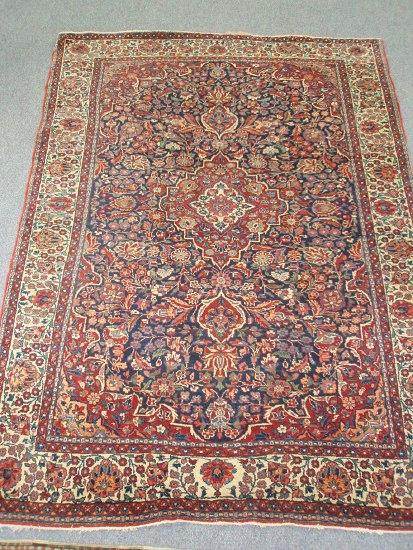 Appraisal: A bordered and figured Kashan rug the central blue ground