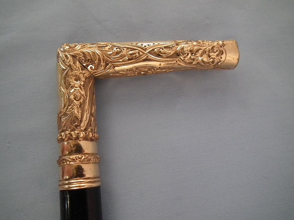 Appraisal: GOLD PLATED CANE Antique gold plated elaborately engraved cane with