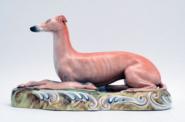 Appraisal: th century figurine of reclining whippet with rabbit on scrolled