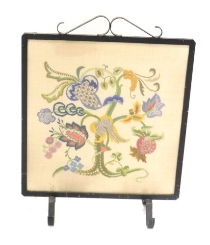 Appraisal: A thC iron framed fire screen with floral embroidered centre