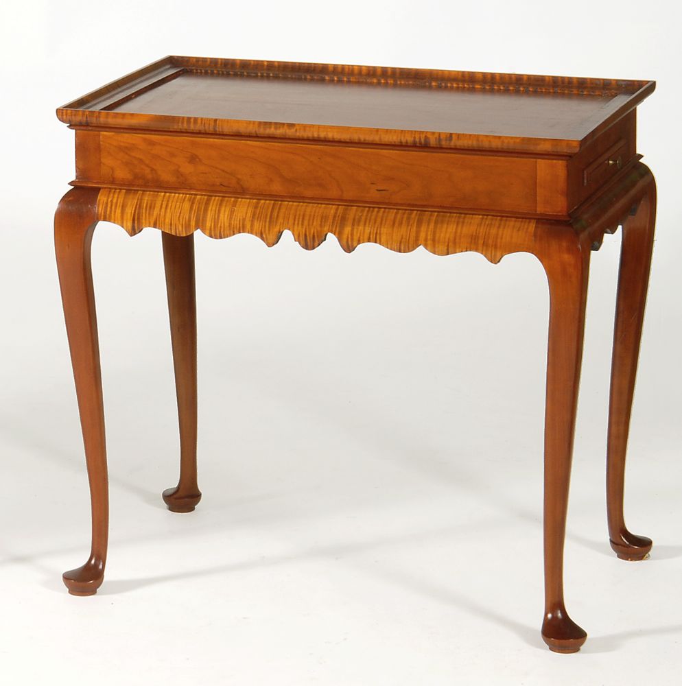 Appraisal: ELDRED WHEELER QUEEN ANNE-STYLE TEA TABLE In cherry and tiger