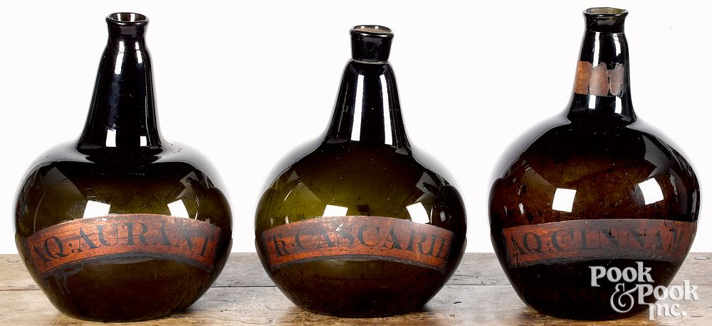 Appraisal: Three blown olive glass apothecary bottles Three blown olive glass