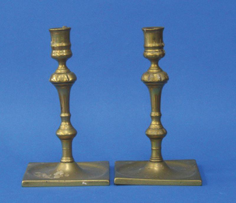 Appraisal: A PAIR OF GEORGE II SQUARE BASE BRASS CANDLESTICKS with