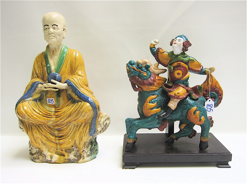 Appraisal: TWO CHINESE GLAZED EARTHENWARE FIGURES the first of a seated