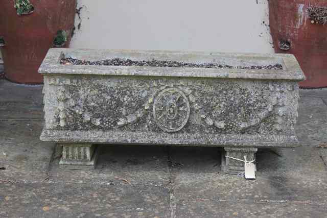 Appraisal: A RECTANGULAR HADDONSTONE TROUGH with ribbon tied husk swags and