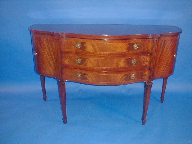 Appraisal: A quality reproduction Regency mahogany serpentine sideboard