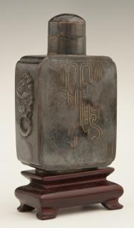 Appraisal: Chinese Carved Hematite Footed Snuff Bottle the e Chinese Carved